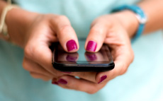 A close up of someone's hand holding a smart phone. 